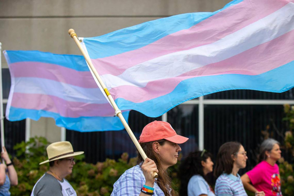 Protesters attend a rally in support of trans youth in schools on June 26, 2023, outside the Fayette County Public Schools central office in Lexington, Kentucky.