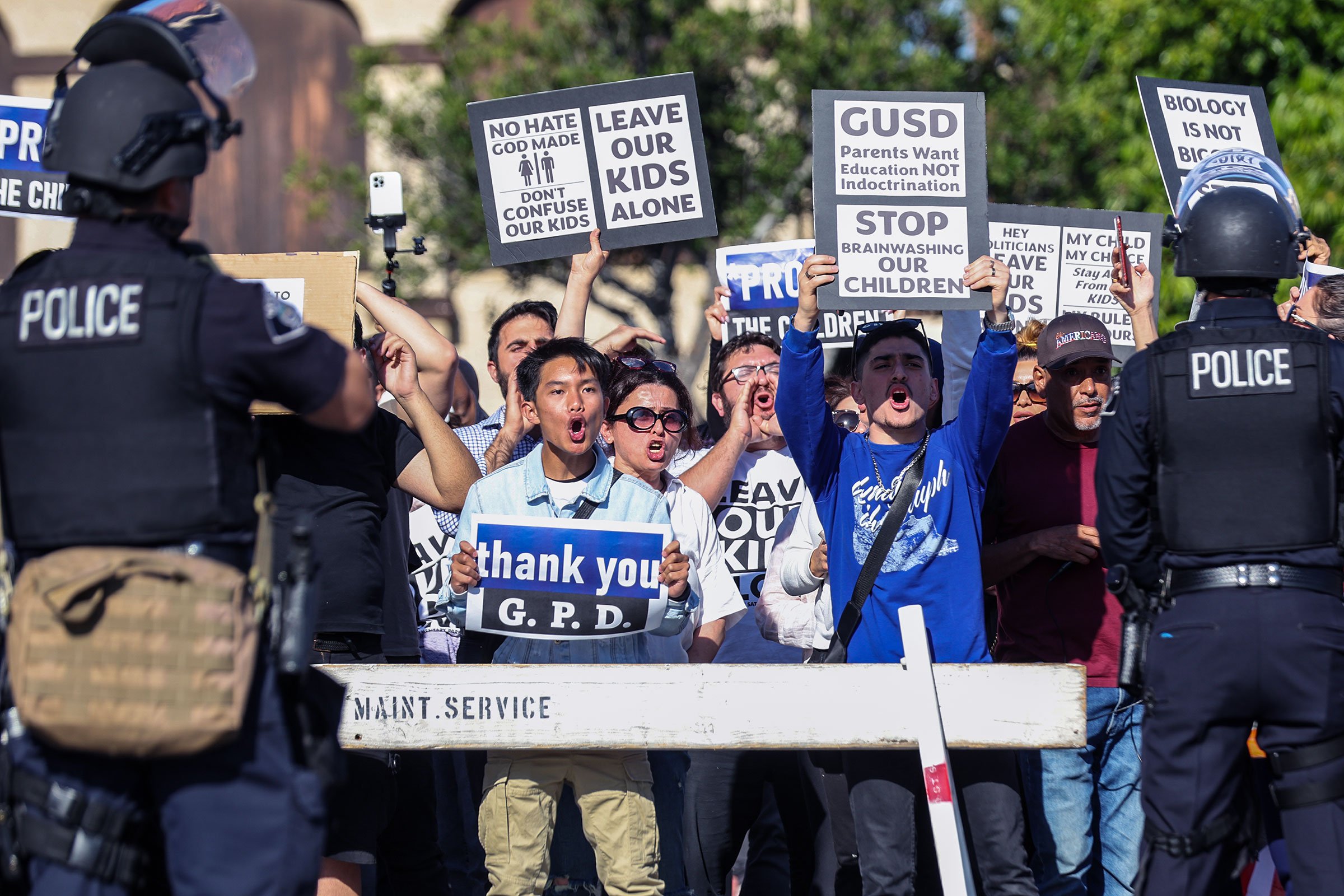 Anti-LGBTQIA+ protesters display signs and chant