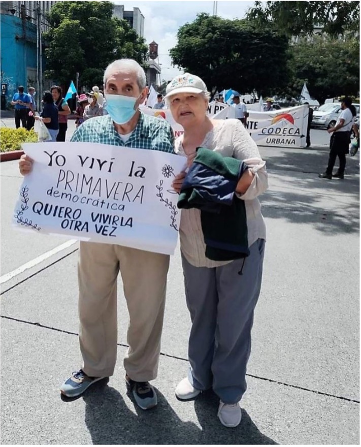 Lors d'une manifestation au Guatemala, un couple tient une pancarte indiquant : J'ai vécu le PRINTEMPS démocratique.  Je veux le revivre.