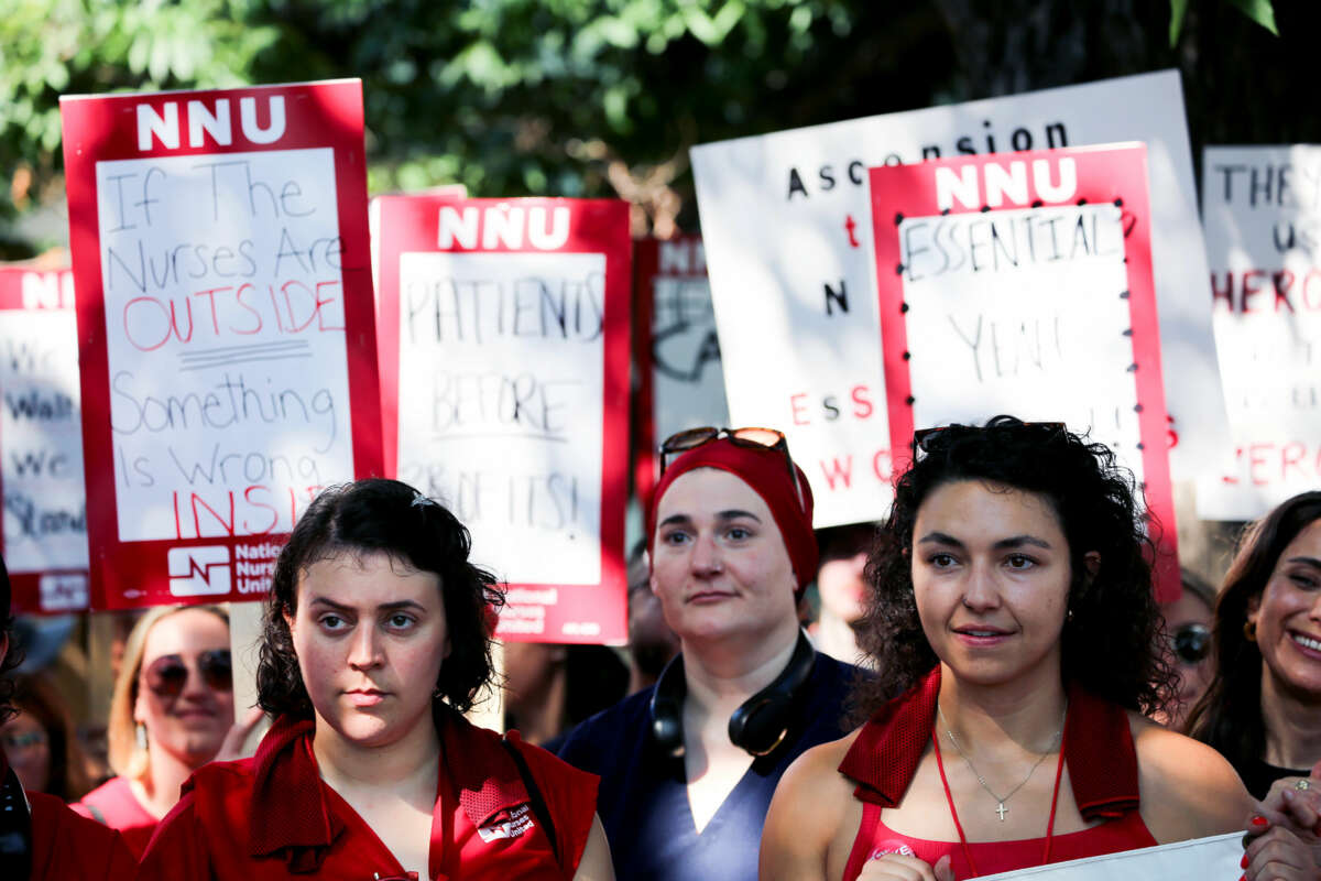 Des personnes vêtues de panneaux rouges soutiennent les infirmières lors d'une grève extérieure