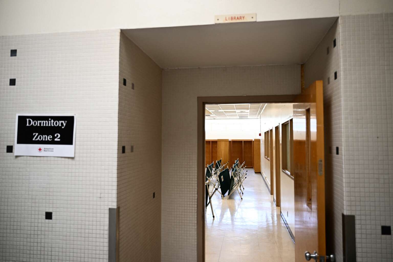 Cots rest in a former Bassett Middle School library set up as a dormitory in a temporary shelter for processed migrants in El Paso, Texas on May 10, 2023.