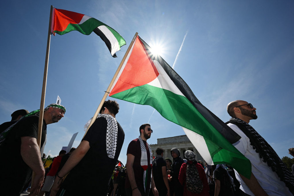 People march with the Palestinian flag on the Washington Mall