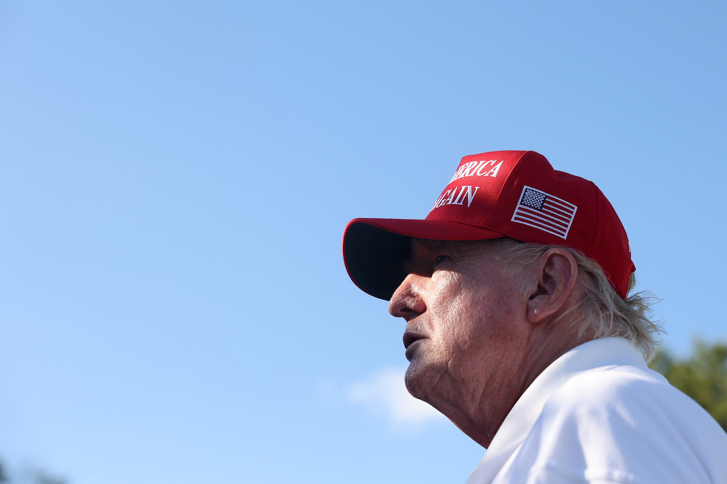 Former President Donald Trump signs autographs hits his shot from the 16th tee during day three of the LIV Golf Invitational Bedminster at Trump National Golf Club on August 13, 2023 in Bedminster, New Jersey.