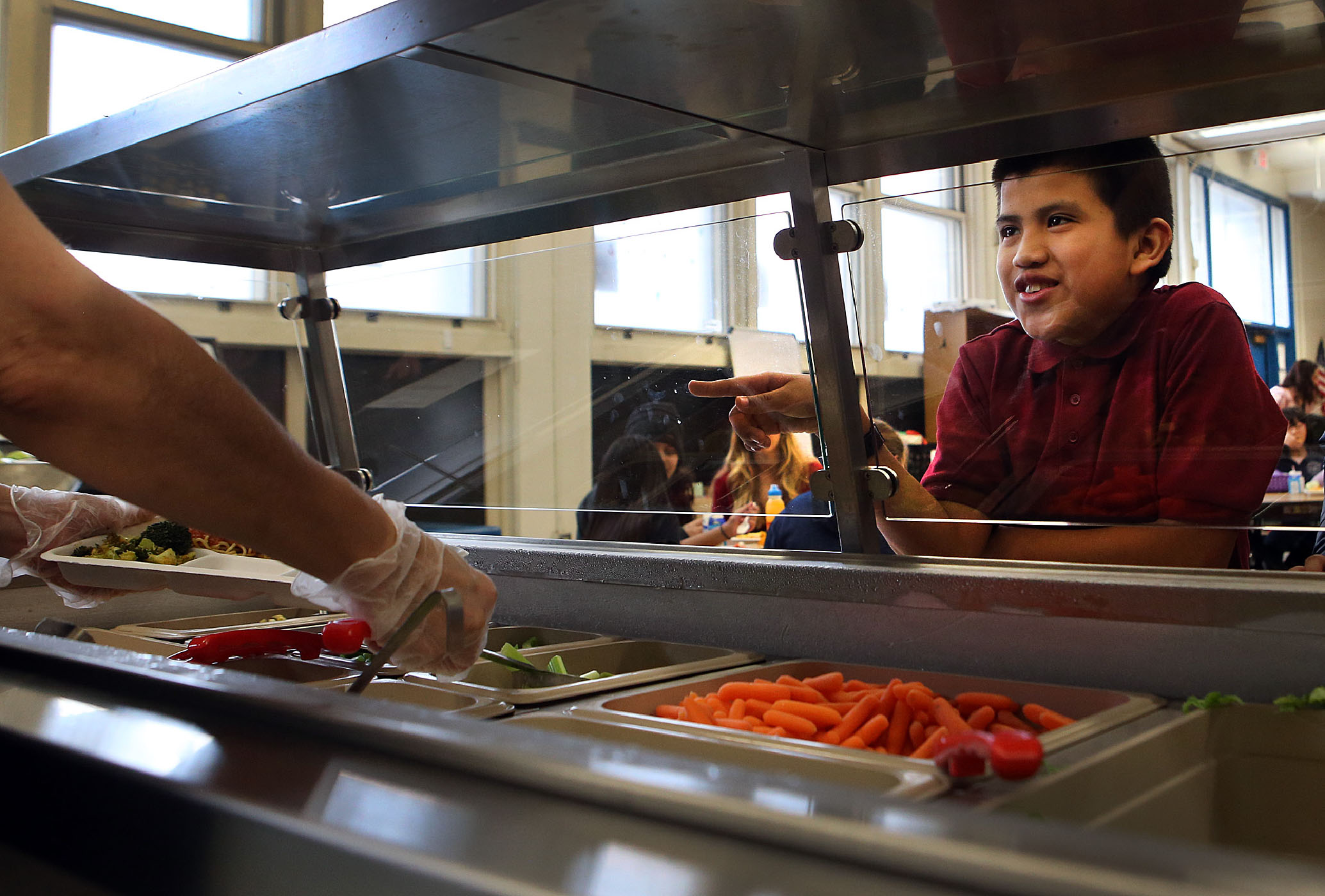 A student chooses his lunch as he takes part in a nutrition program at Bradley Elementary School in the neighborhood of East Boston in Boston, Massachusetts, on January 11, 2018.