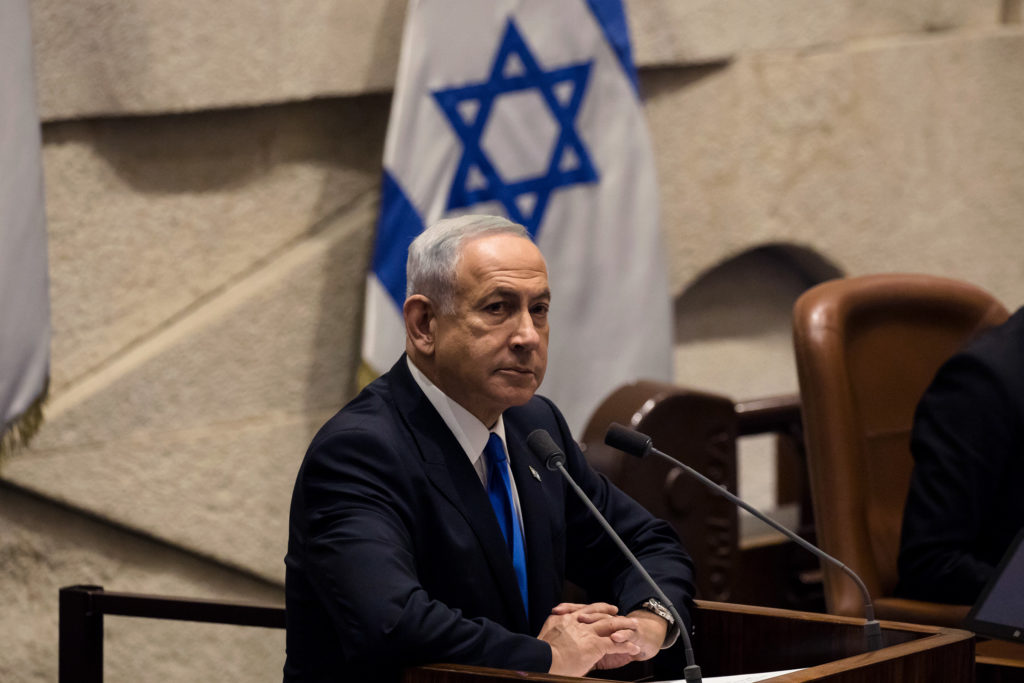 Benjamin Netanyahu stands at a podium