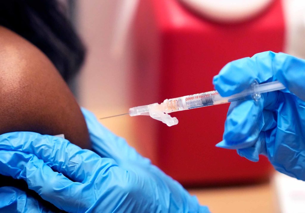 A medical worker administers a dose of the covid-19 vaccine