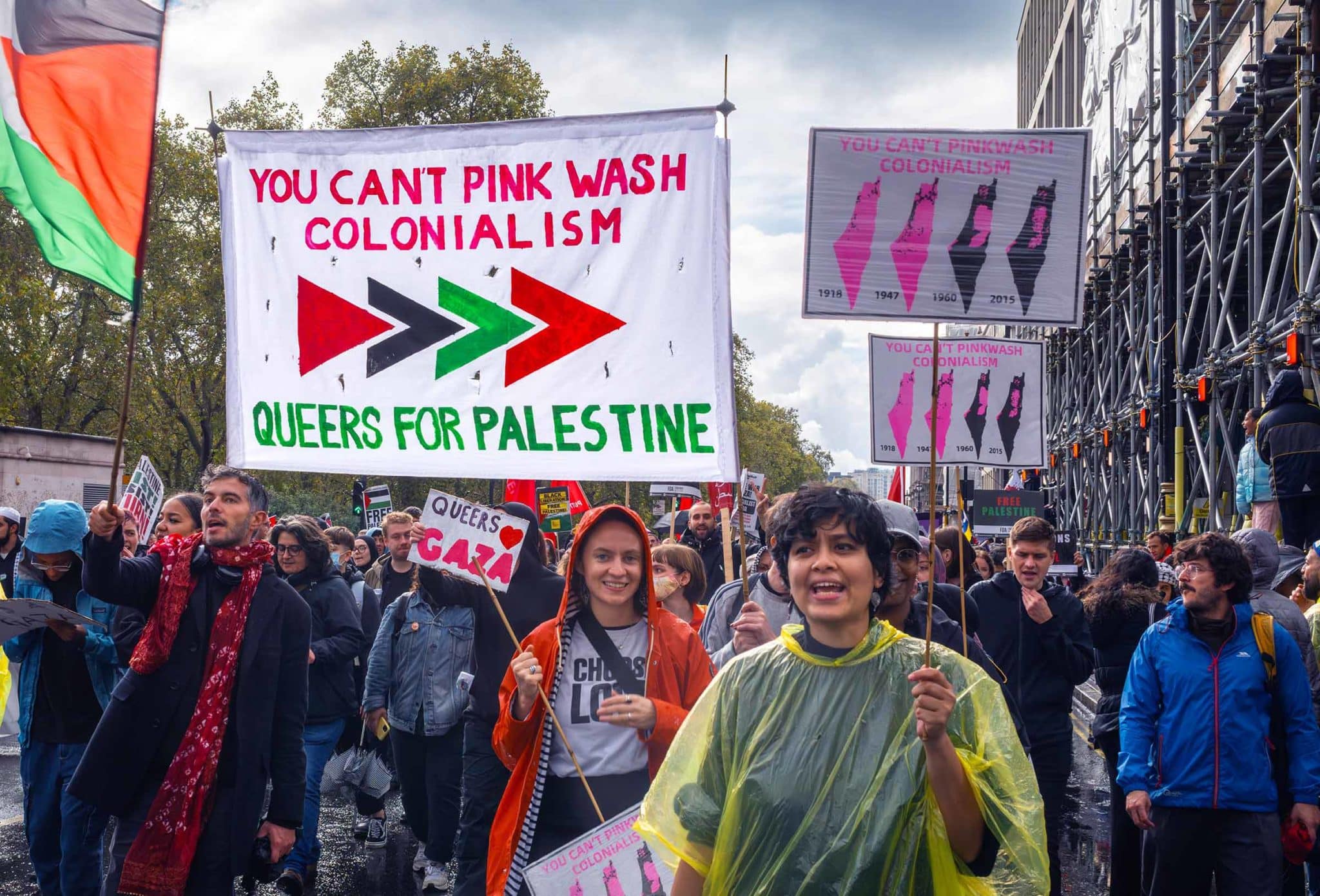 Protesters march under a banner reading "YOU CAN