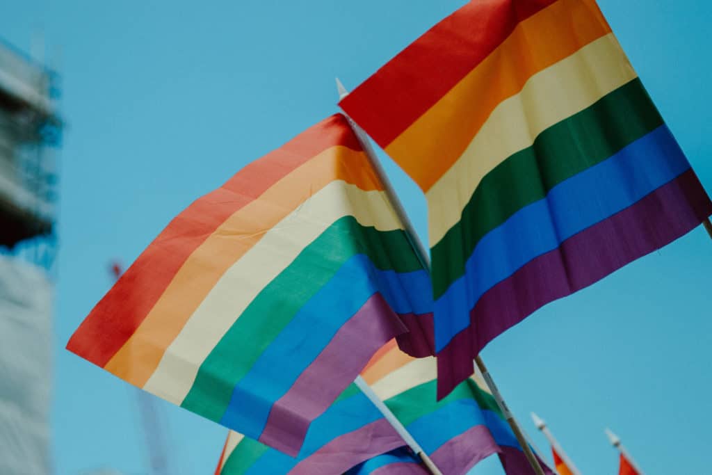 Pride flags flying over blue sky