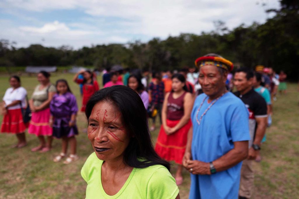 Members of the Siekopai nation stand during a presentation