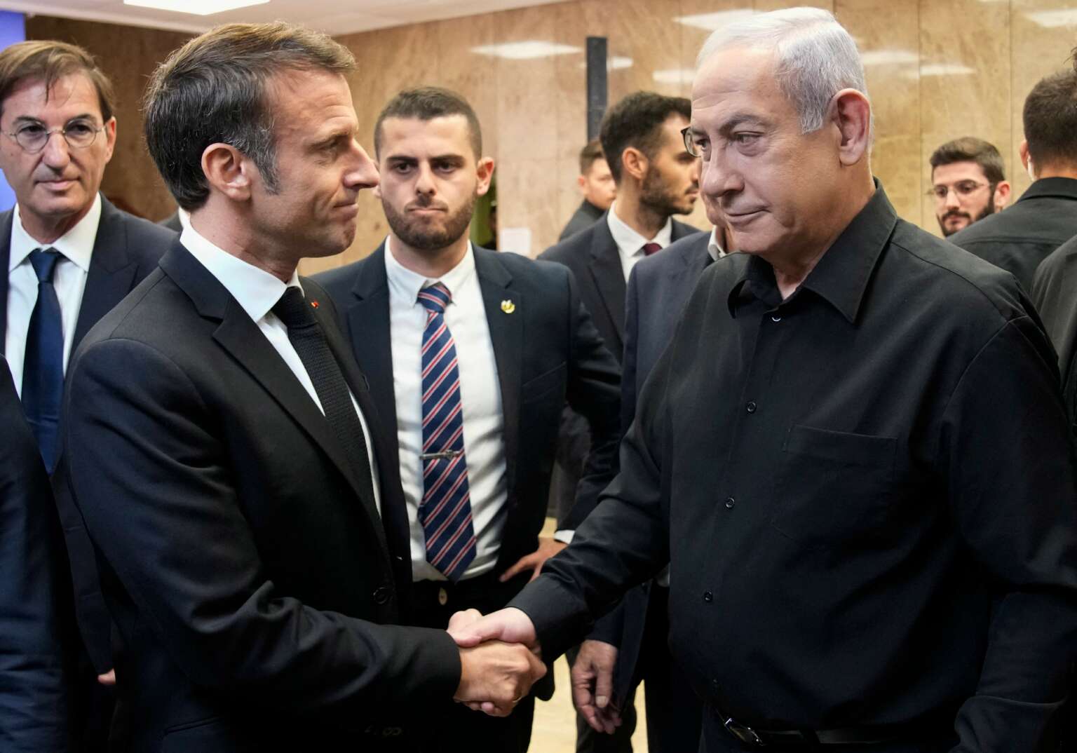 Israeli Prime Minister Benjamin Netanyahu (R) shakes hands with French President Emmanuel Macron (L) after their joint press conference in Jerusalem, on October 24, 2023.