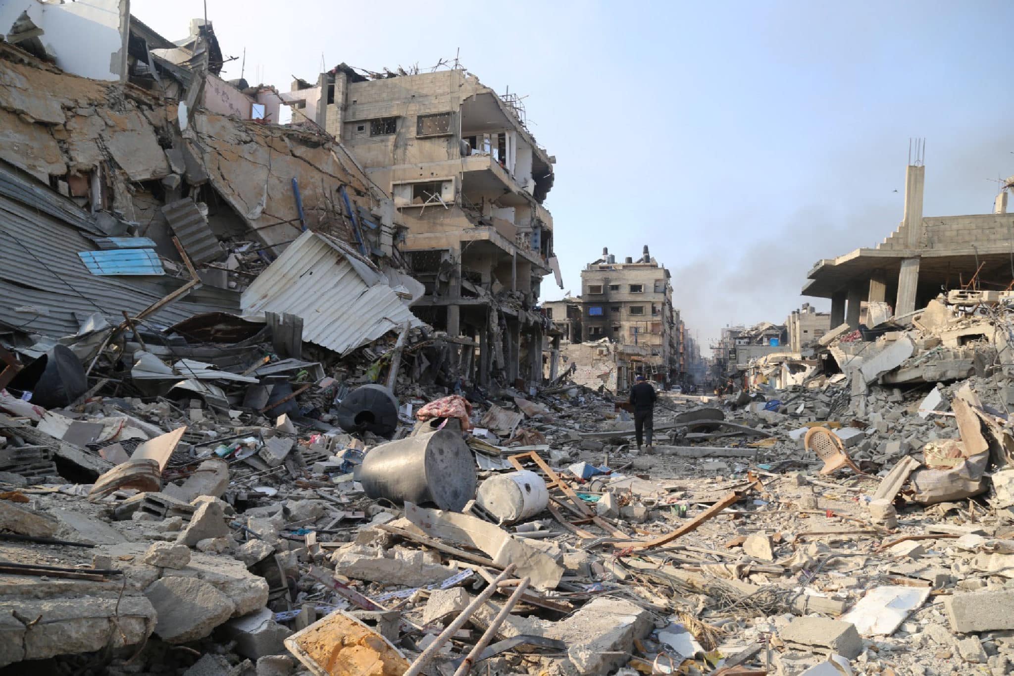 A man walks among the rubble of destroyed buildings in the northern Gaza Strip town of Beit Lahia, on January 8, 2024.