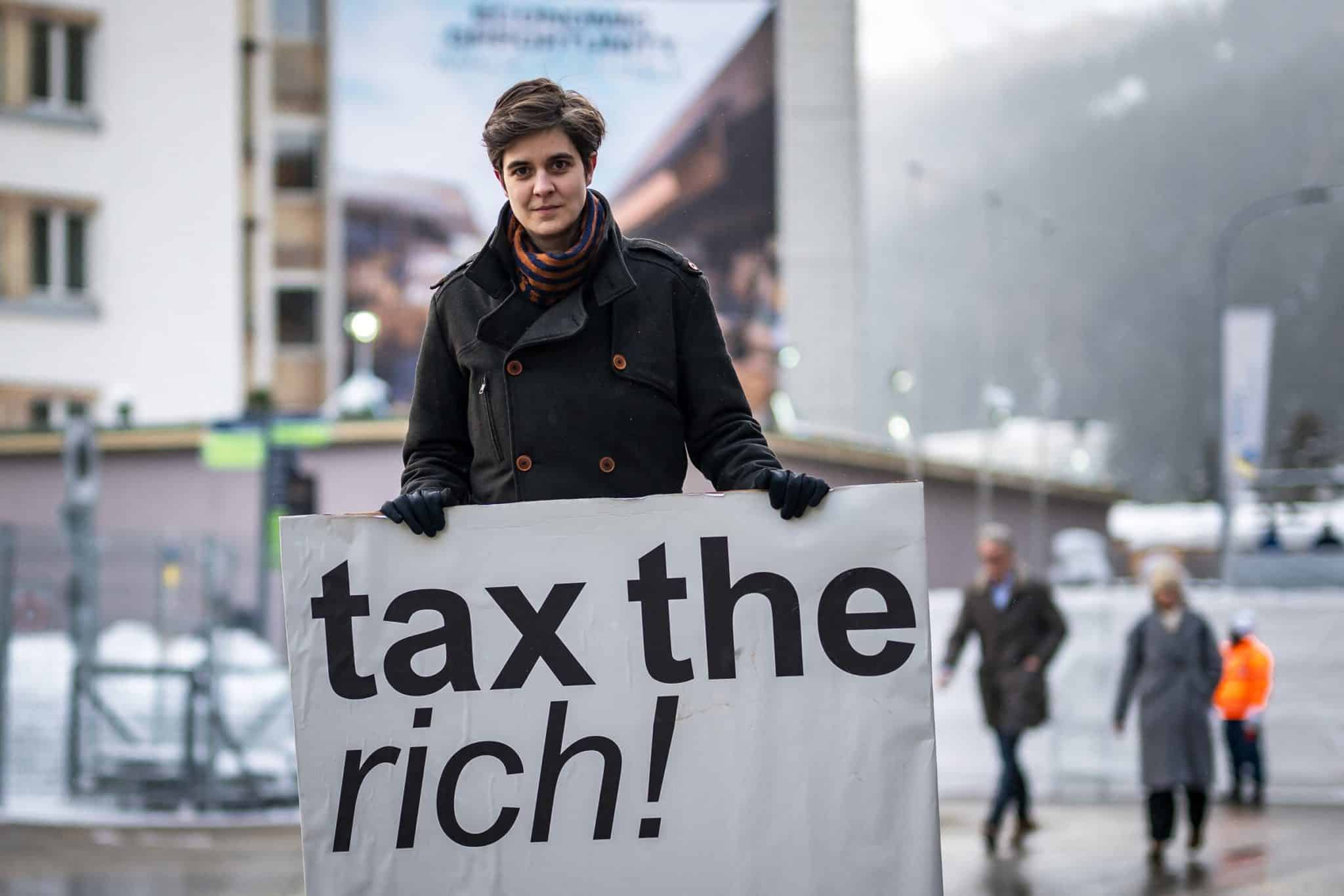 BNSF heiress Marlene Engelhorn holds a sign reading