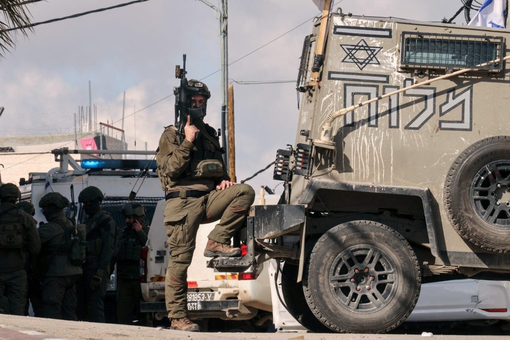 An idf soldier poses with a gun