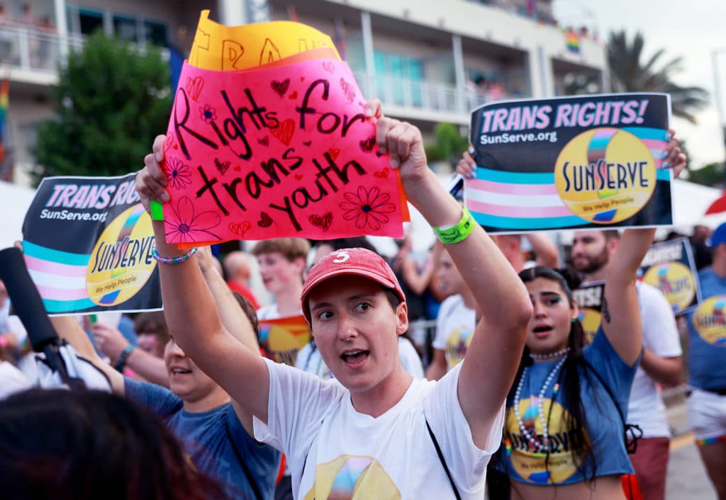 A protester holds a sign reading