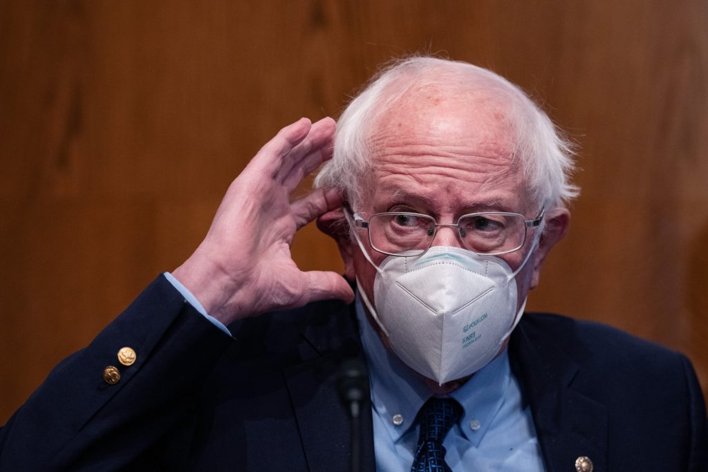 Bernie Sanders scratches his ear