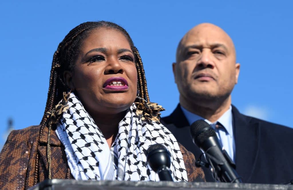 Cori Bush speaks at a podium on the steps of the US Capitol